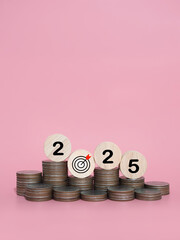 Wooden blocks with the number 2025 on stack of coins. The concept of saving money, Financial,...