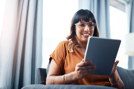 Woman, tablet and smile on sofa for movie streaming, relax and social media with communication. Female person, technology and happy on couch for film, app subscription and online shopping in house
