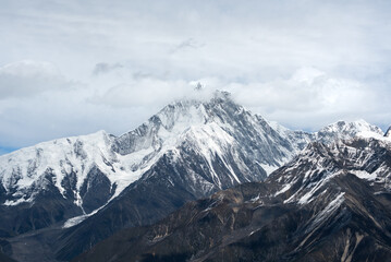 Fototapeta premium Minya Konka (Mount Gongga, Tibetan Snow Mountain) - in Sichuan Province, China. View from the west at Zimei Mountain Pass. Highest Mountain in Sichuan Province China.