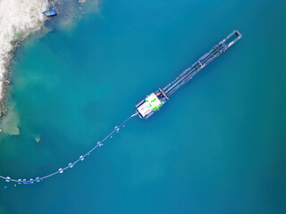 Top down view of a dredger extracting gravel, gravel pit, aerial view. 