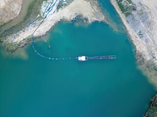 Top down view of a dredger extracting gravel, gravel pit, aerial view. 