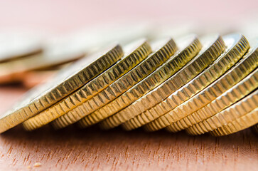 Fototapeta premium Close up of golden coins suitable for advertisement, slide presentation relating to financial etc