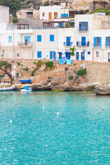 White houses with blue shutters on the island Levanzo in Sicily.