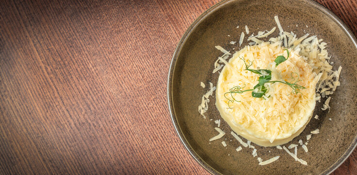 mashed potatoes with Parmesan cheese on wooden background. Top view, copy space