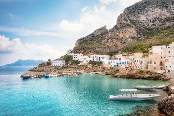 Levanzo island in Sicily with white houses with blue shutters and beautuful turquoise water.