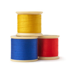 primary colors spool of cotton embroidery sewing thread isolated white background, blue, yellow and...