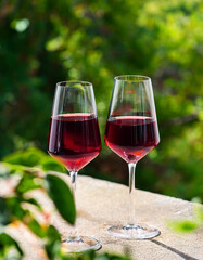 Two glasses with alcoholic cocktail, red wine. Tasty drink. Winery production. Delicious beverage