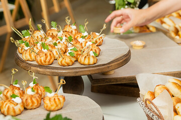 Delicious tartlets prepared for a buffet at the event. Food for a coffee break at a conference