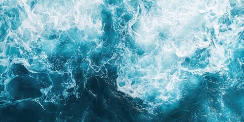 Obraz premium Turquoise ocean waters with foamy waves, creating a textured effect.