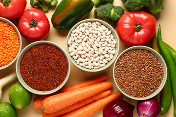 Different fresh vegetables and cereals on orange background