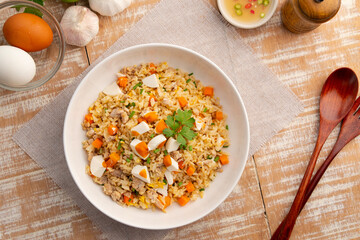 Salted eggs fried rice,stir fry egg with cooked rice minced pork and salted egg in white plate.Top...