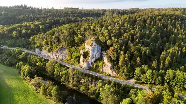 Aerial footage of circle over road and famous rock (Gespaltener Fels) at the Danube River near Sigmaringen