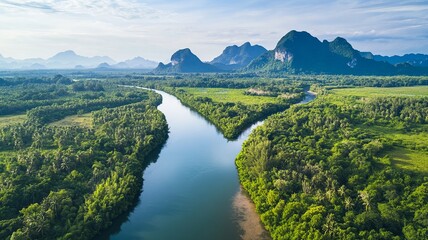 Obraz premium Beautiful natural scenery of river in southeast Asia tropical green forest with mountains in background, aerial view drone shot 