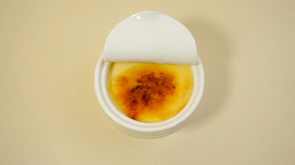 Creme brulee  on a isolated cream background. Copy space