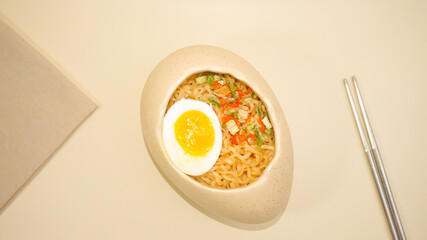 Noodles with egg in a unique egg-shaped bowl

