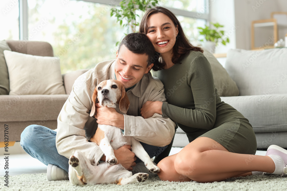 Poster young couple with cute beagle dog at home