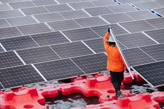 Worker Installation Floating Solar Panels. Worker Maintenance Replace Solar Panel. Solar photovoltaic panel system in the water pond lake.