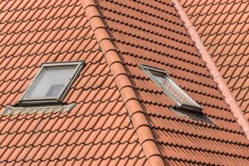 Windows on a tiled roof. Upper floor. Mansard window. Tilted windows. Architectural solution....