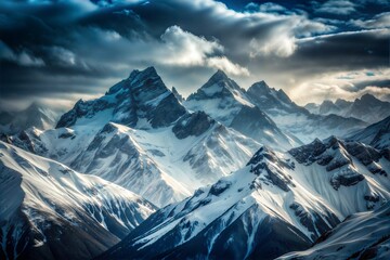 Majestic snow,capped mountains under dramatic cloudy sky during winter morning