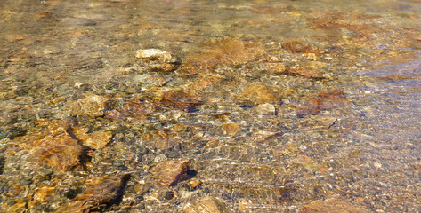 Yosemite clear mountain stream with rocks shimmering in the water. 
