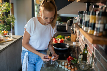 Young woman preparing fresh vegetables in a modern kitchen
