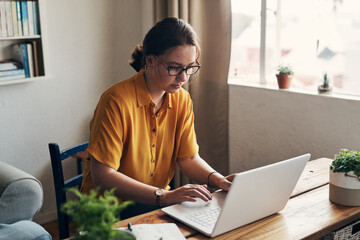 Woman, laptop and remote work for planning in home, online and research for writing article. Female person, check report and editing language on transcription, typing and upload journal on website