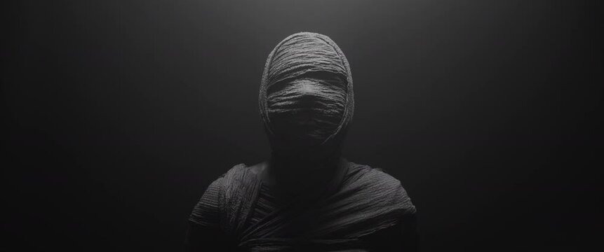 A mummy of a woman against the dark background