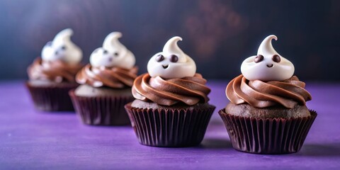 Chocolate cupcakes with ghost shaped frosting and eyes on purple background for spooky Halloween decorations