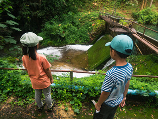 Young Explorers Marveling at Nature's Cascade
