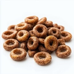 A close-up of a pile of chocolate cereal rings on a white surface.