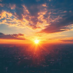 A breathtaking sunset over a cityscape, casting golden rays across the horizon. The vibrant sky is adorned with dramatic clouds.