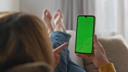 Woman hands watching chromakey phone laying sofa closeup. Lady tapping screen