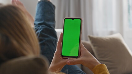 Lady reading green screen smartphone at home closeup. Relaxed girl using phone
