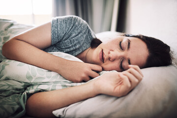 Woman, tired and sleeping in house for nap, relax and exhausted with peace, comfort and weekend rest in bed. Female person, fatigue and asleep in bedroom for break, morning and burnout with pillow