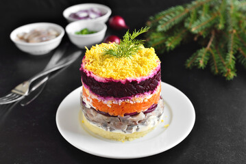 Layered salad with beet, herring, carrots and potatoes