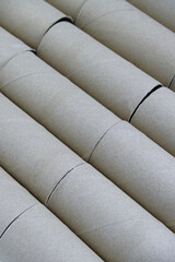 Paper background of tissue core. Close-up cylinder of tissue paper core with concepts of orderly, recycle, brown, eco-friendly, and abstract concepts. Vertical texture background of brown paper roll.