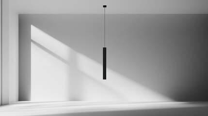 A minimalist room with a single black pendant light hanging from the ceiling