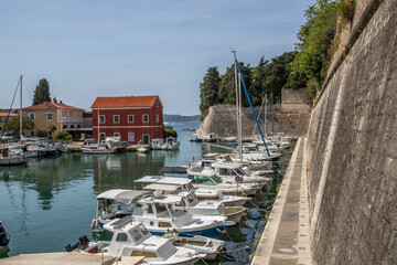 Zadarske gradske zidine, Historic harbor with small boats and a distinctive red house. In front of...