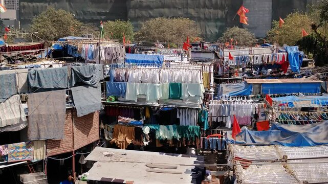 Dhobi ghat slums Mumbai, India, laundry area. The washers, known as dhobis, work in the open to clean clothes and linens from Mumbai's hotels and hospitals.