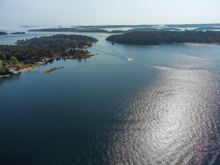 Small motorboats in the swedish archipelago near Stockholm, late summer, patchy fog, sunshine and idyllig landscape