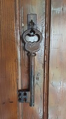 Fototapeta premium Skeleton key hanging on Solid wood door