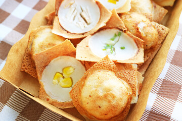 Closeup of Sweet and fragrant Thai coconut milk pancakes called Kanom Krok, one of the popular street food in Thailand