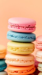 Fototapeta premium Colorful stack of pastel macarons on peach