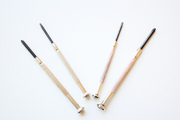 Set of four long screwdrivers isolated on white background. Tools and equipment for home and industrial repair or maintenance services.