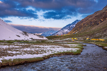 View during sunrise from Rupin pass trek campsite.This trek is full of diversity from majestic...