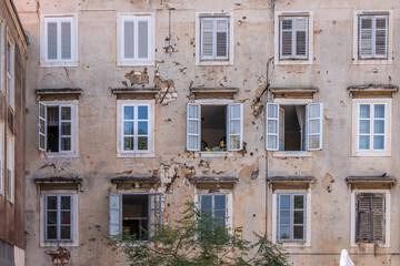 Window of an old building showing bullet holes from the Balkan War. Window front or house front in the historic old town of Zadar, Adriatic Sea, Dalmatia, Croatia