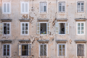 Window of an old building showing bullet holes from the Balkan War. Window front or house front in the historic old town of Zadar, Adriatic Sea, Dalmatia, Croatia