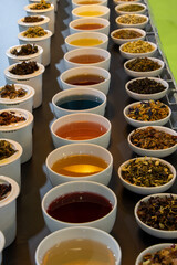 Various herbal teas in porcelain cups and bowls