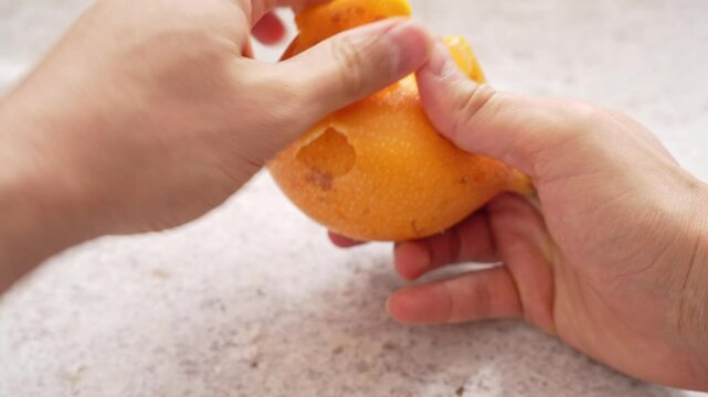 Hands Opening Sweet Granadilla, Revealing Pulp and Seeds Inside