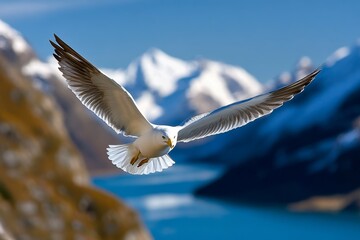 Bird soaring over the mountains, snowy peaks below as it navigates the high altitudes with ease and power